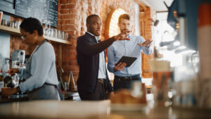 Venue owners going over their hotel point of sale systems behind the counter.