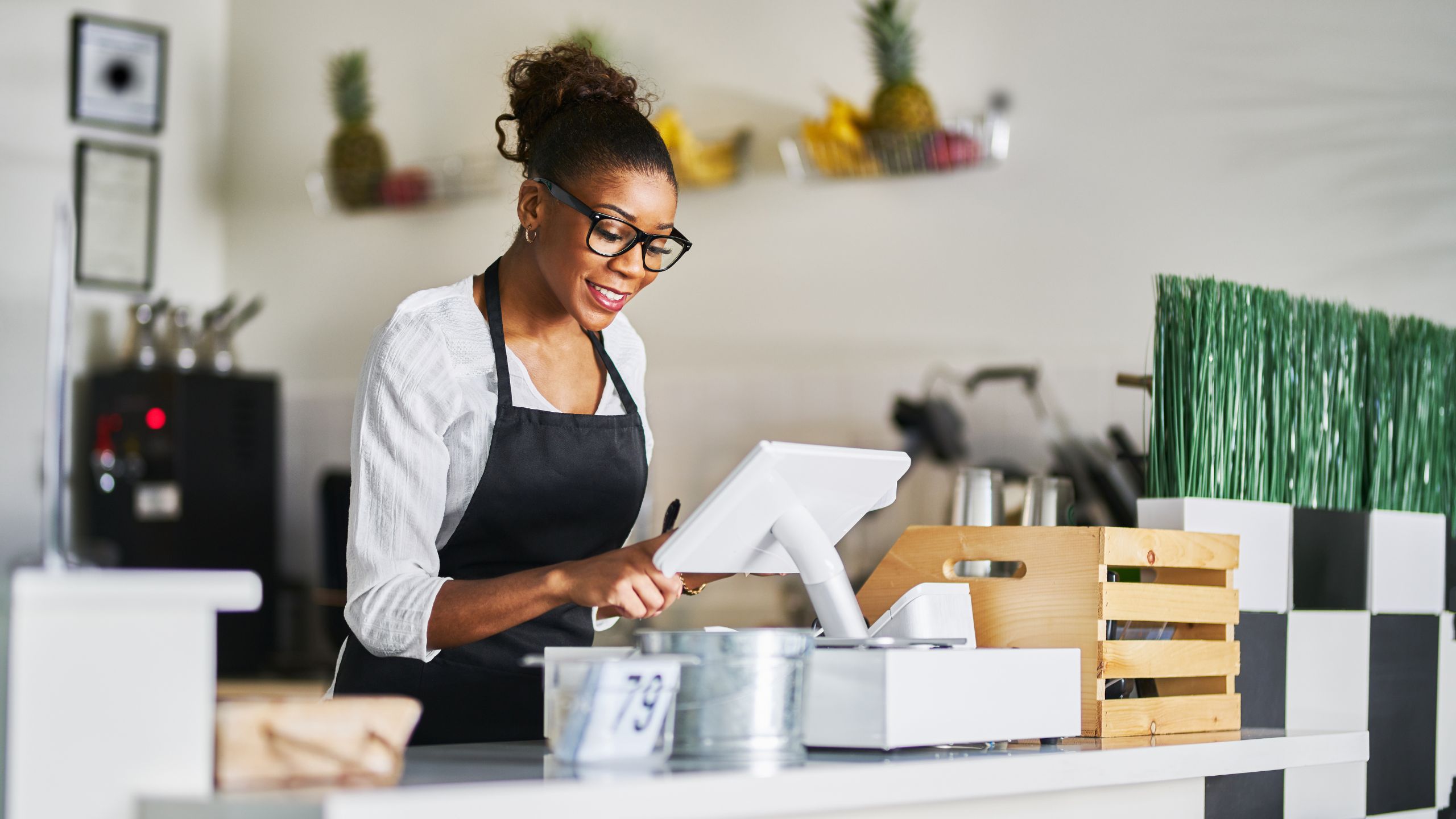 A woman operating a Retail Systems POS.